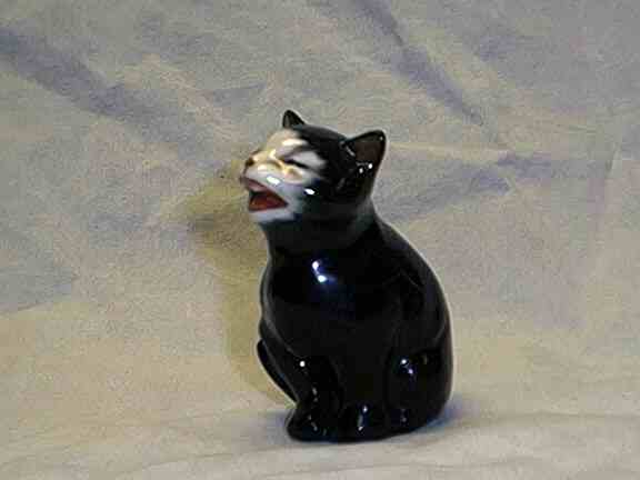 Photo of figurine of black cat laughing